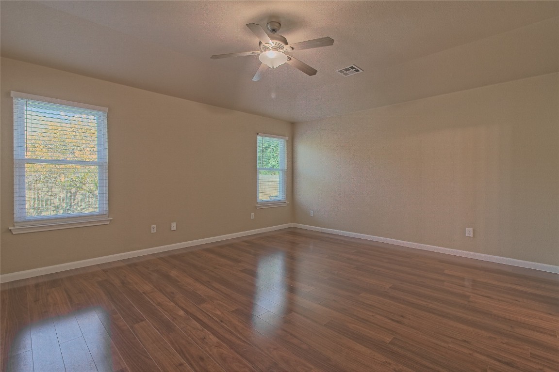 3112 Clinton Place Round Rock, TX 78665 - Photo 21 of 36 wooden floor in an empty room with a window