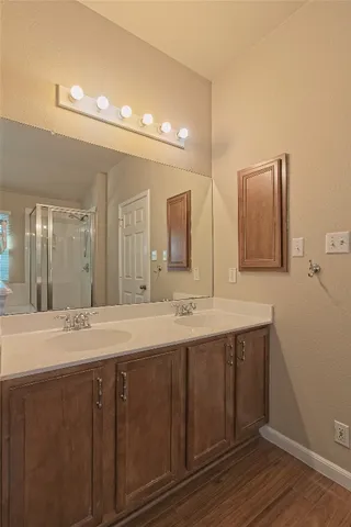 a bathroom with a double vanity sink and a mirror