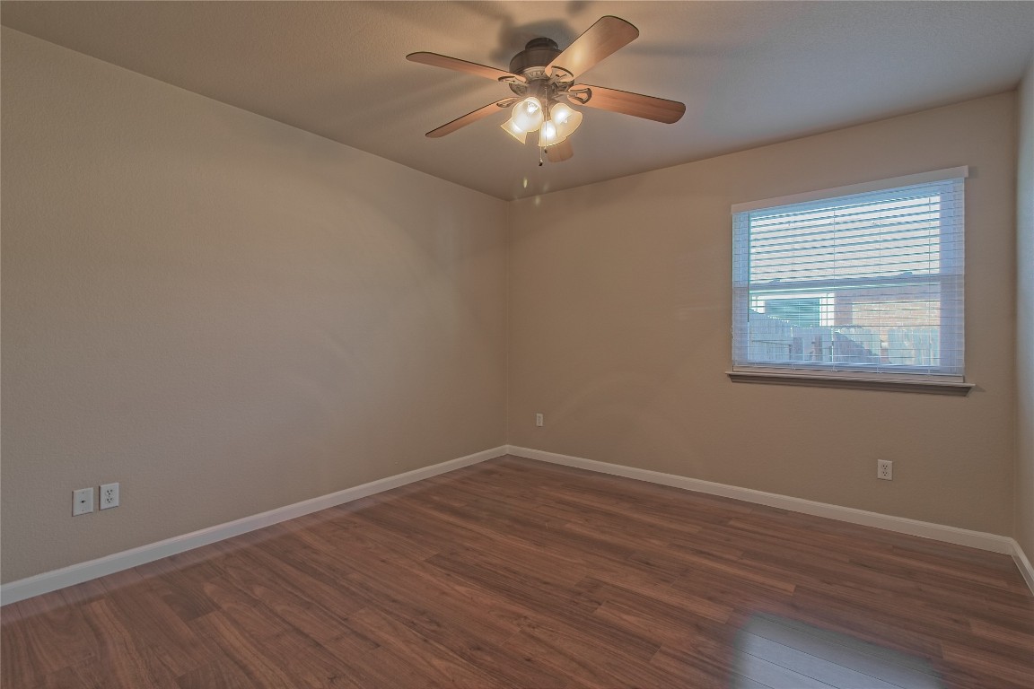 3112 Clinton Place Round Rock, TX 78665 - Photo 25 of 36 a view of a room with wooden floor and a ceiling fan