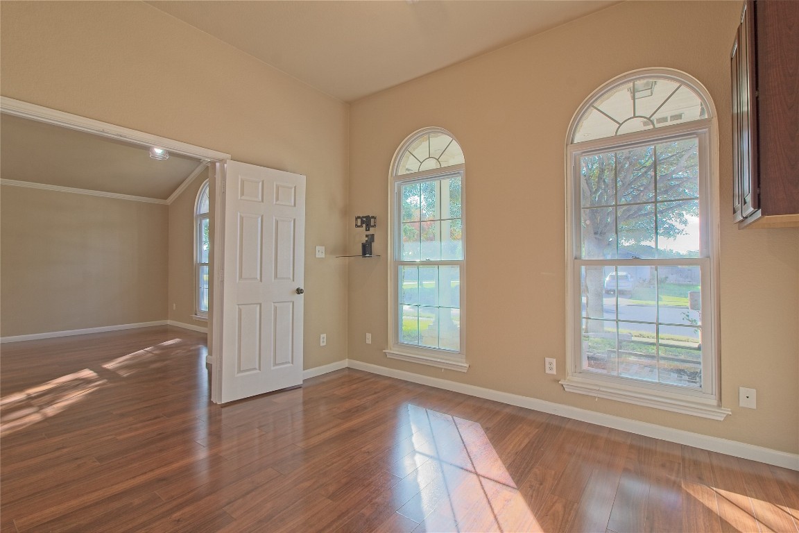 3112 Clinton Place Round Rock, TX 78665 - Photo 10 of 36 an empty room with wooden floor cabinet and windows