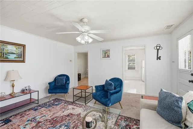 a living room with furniture a rug and a window
