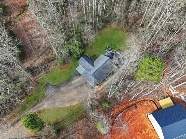 an aerial view of a house with a yard