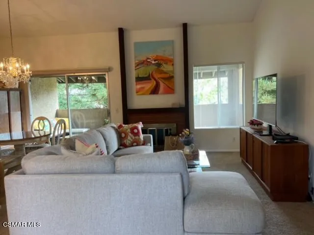 a living room with fireplace furniture and a flat screen tv