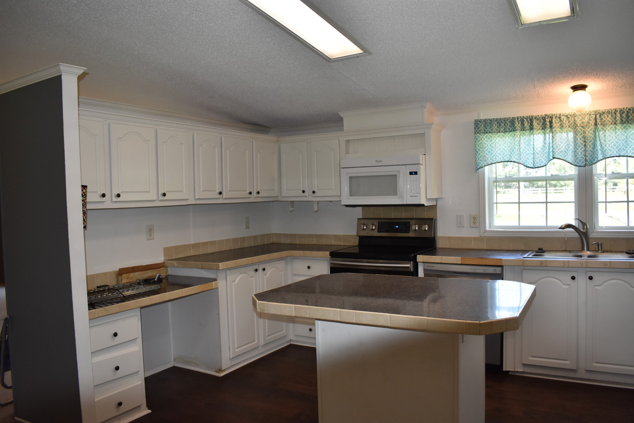 4576 Kedron Road Spring Hill, TN 37174 - Photo 13 of 35 a kitchen with granite countertop a sink stove and cabinets
