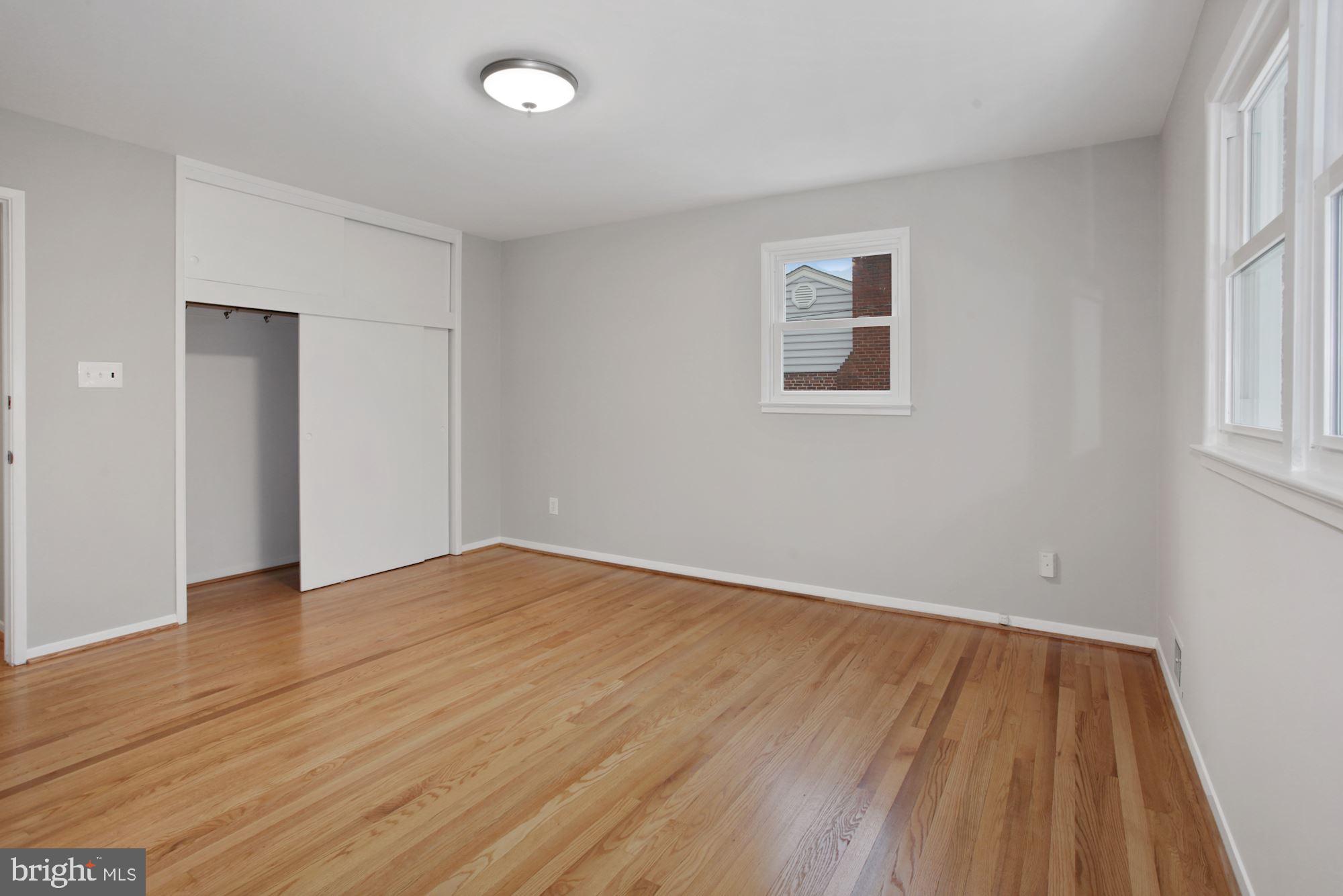 5318 Inverchapel Road Springfield, VA 22151 - Photo 14 of 19 an empty room with wooden floor and windows