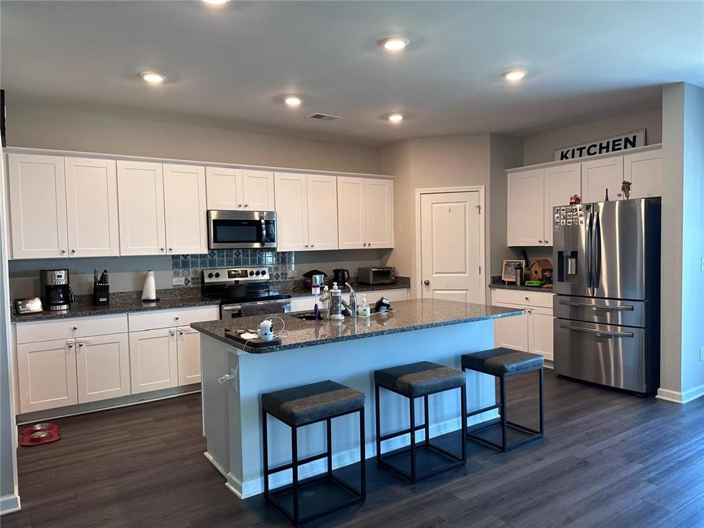 53 Seed Lane Pendergrass, GA 30567 - Photo 2 of 22 a kitchen with refrigerator cabinets and wooden floor