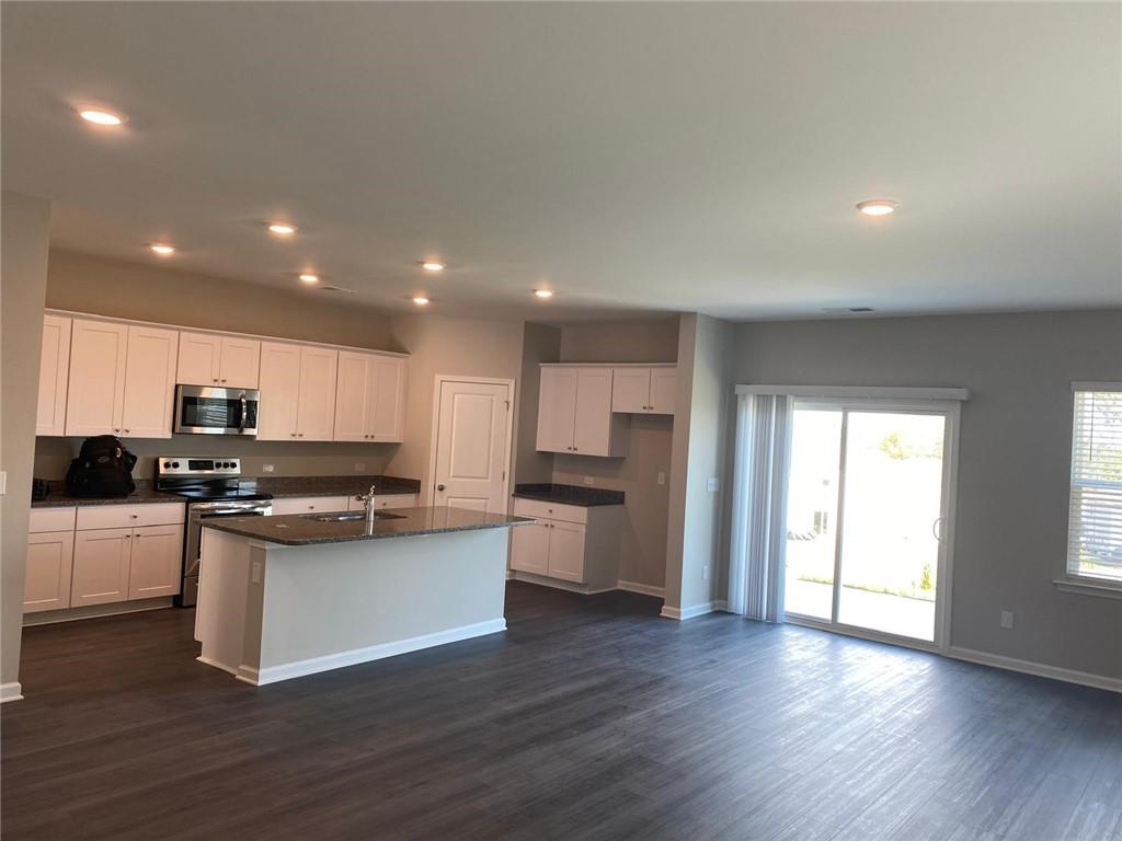 53 Seed Lane Pendergrass, GA 30567 - Photo 3 of 22 a kitchen with stainless steel appliances granite countertop a stove a sink and a refrigerator