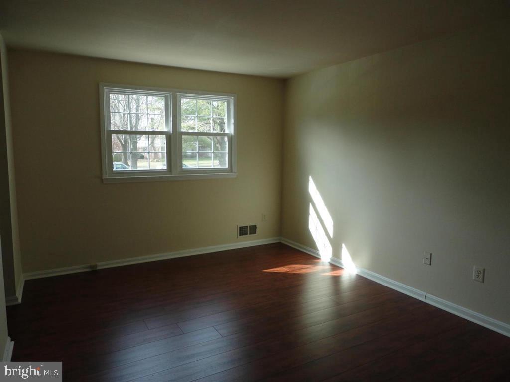 9120 Conservation Way Springfield, VA 22153 - Photo 12 of 19 an empty room with wooden floor and windows