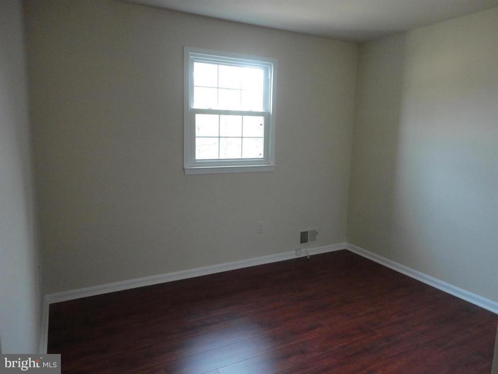 9120 Conservation Way Springfield, VA 22153 - Photo 5 of 19 an empty room with wooden floor and windows