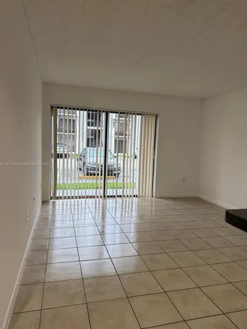 a view of an empty room and a window