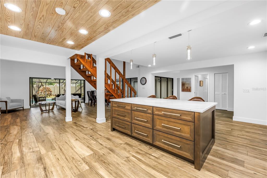 4605 Stone Ridge Trail Sarasota, FL 34232 - Photo 15 of 56 a living room with large couches and kitchen view with wooden floor