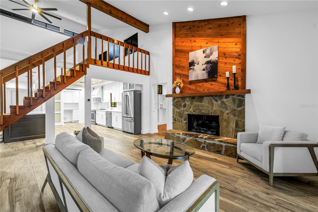 4605 Stone Ridge Trail Sarasota, FL 34232 - Photo 18 of 56 a living room with furniture a fireplace and a floor to ceiling window