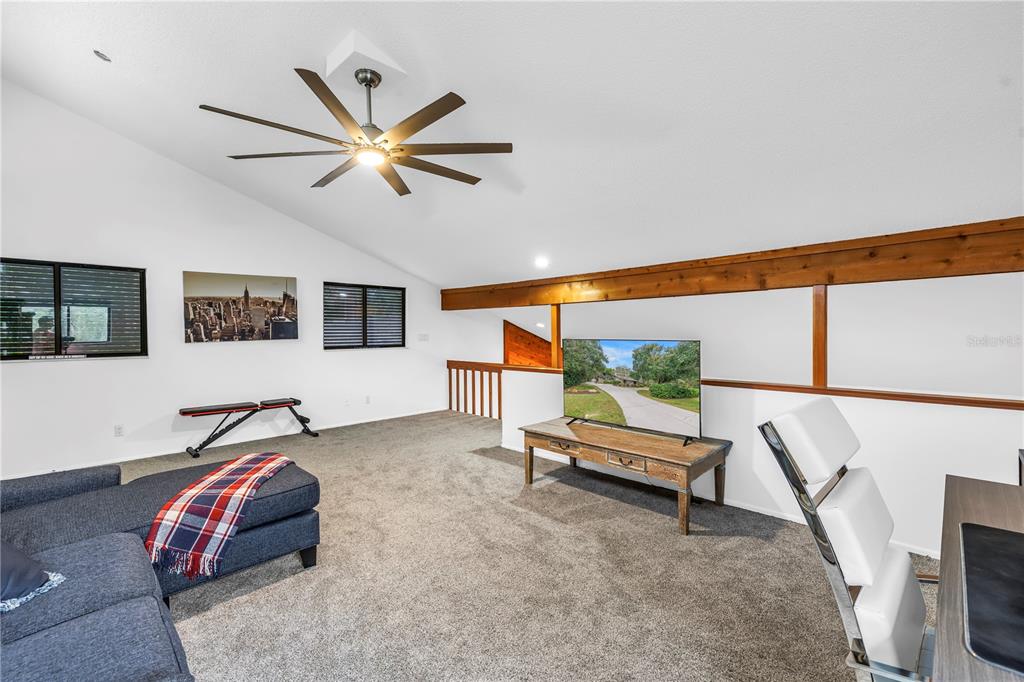 4605 Stone Ridge Trail Sarasota, FL 34232 - Photo 25 of 56 a bedroom with a bed and a flat screen tv