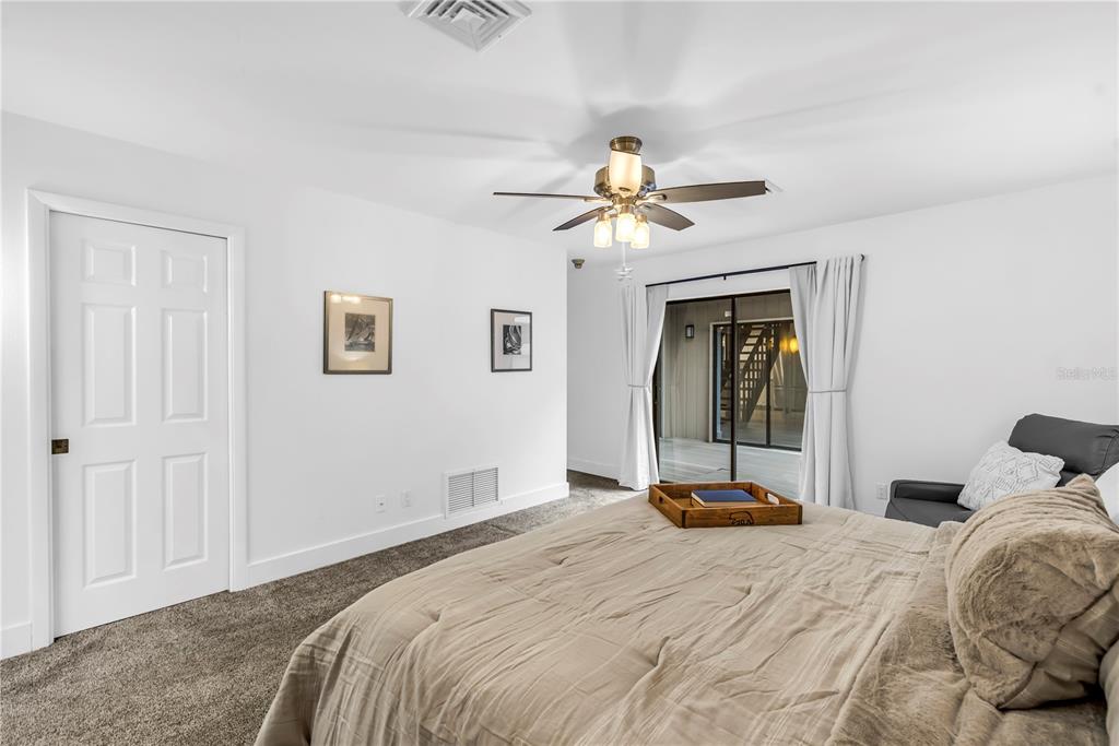 4605 Stone Ridge Trail Sarasota, FL 34232 - Photo 29 of 56 a bedroom with a bed and a chandelier