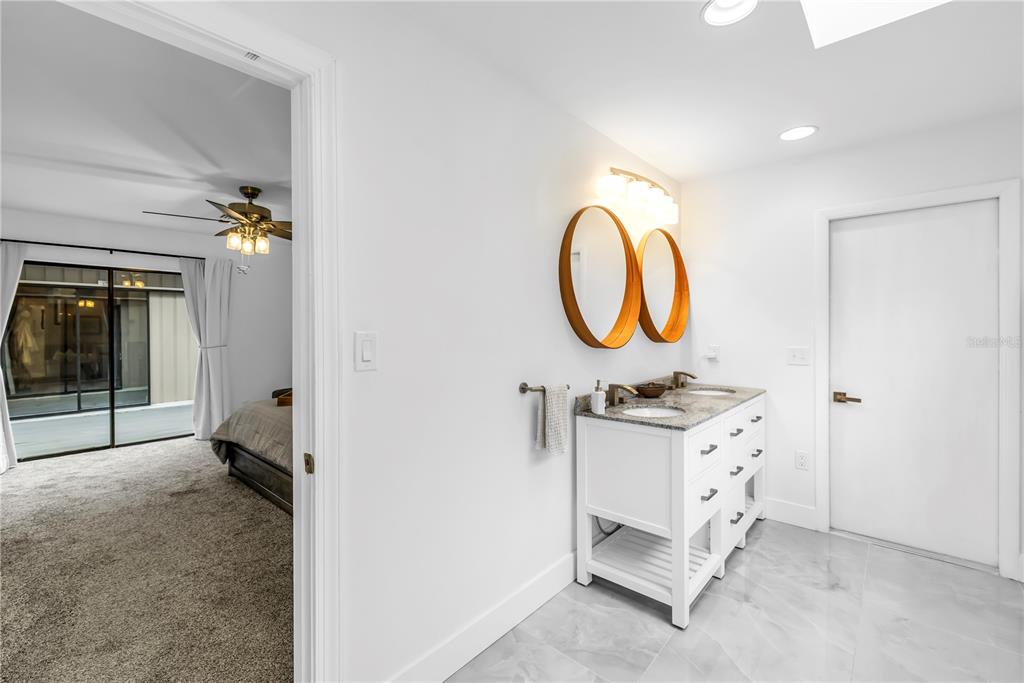 4605 Stone Ridge Trail Sarasota, FL 34232 - Photo 30 of 56 a bathroom with a sink mirror and vanity
