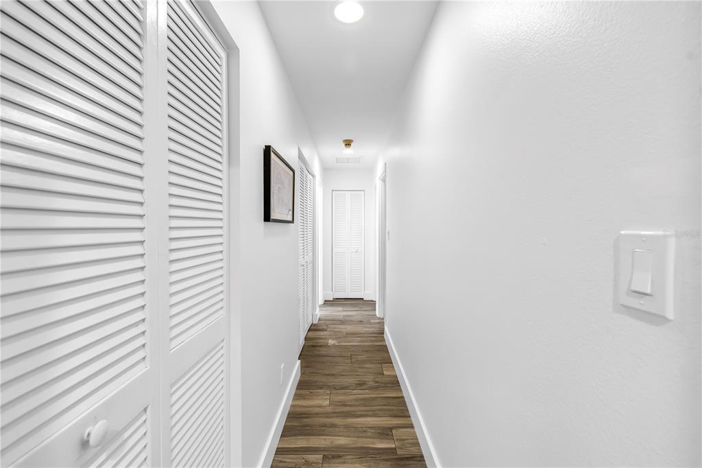 4605 Stone Ridge Trail Sarasota, FL 34232 - Photo 34 of 56 a view of a hallway with wooden floor