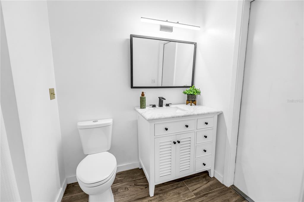 4605 Stone Ridge Trail Sarasota, FL 34232 - Photo 47 of 56 a bathroom with a granite countertop toilet sink and mirror