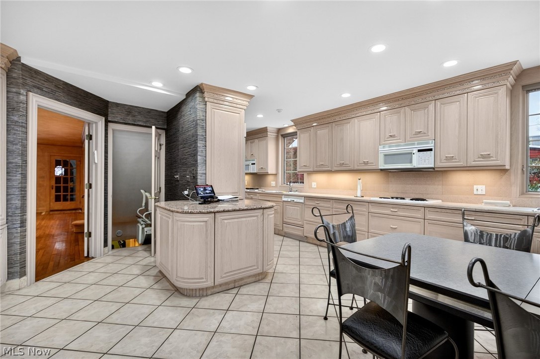 3498 Bainbridge Road Cleveland Heights, OH 44118 - Photo 23 of 50 Kitchen featuring white appliances, light tile patterned flooring, healthy amount of natural light, light stone counters, and recessed lighting