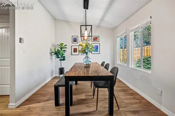 a view of a dining room with furniture window and wooden floor