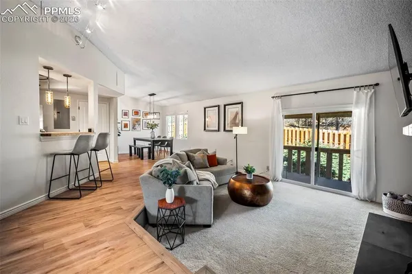 a living room with furniture a window and a table