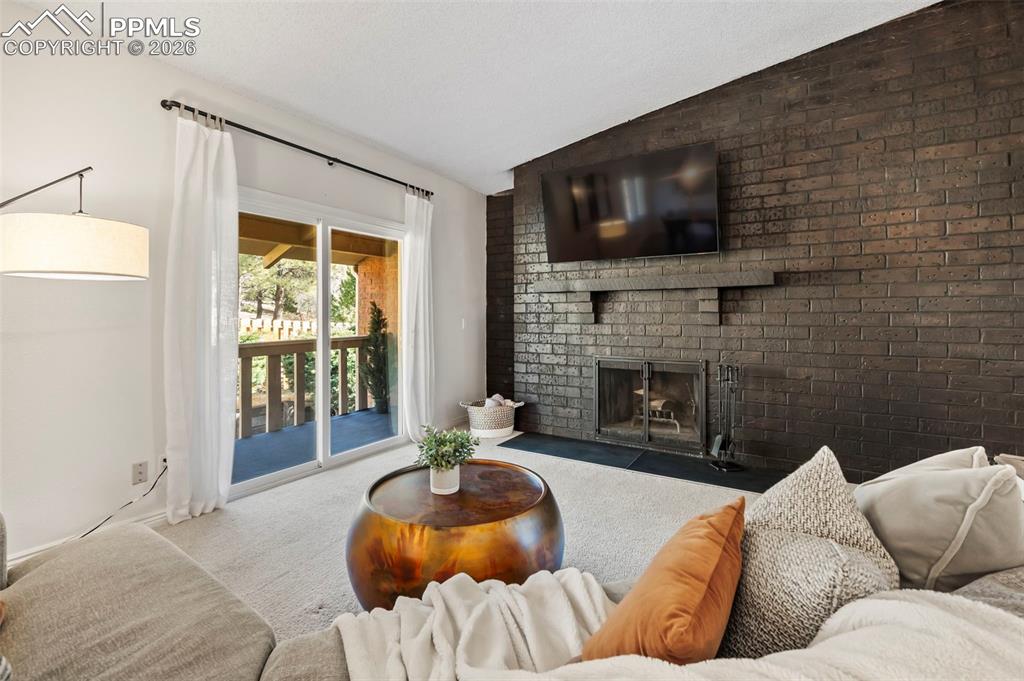 1682 Deer Creek Road Monument, CO 80132 - Photo 7 of 39 Seamless access to one of the two private balconies, extending living space into the surrounding landscape