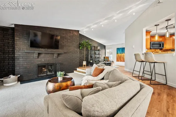a living room with fireplace furniture and a flat screen tv