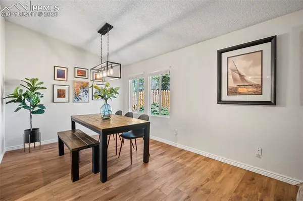 a view of a dining room with furniture window and wooden floor