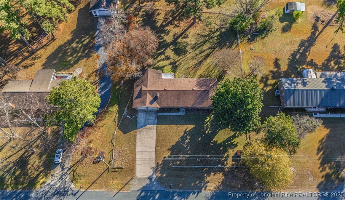255 Foxcroft Road Whispering Pines, NC 28327 - Photo 31 of 31 a view of a house with a yard