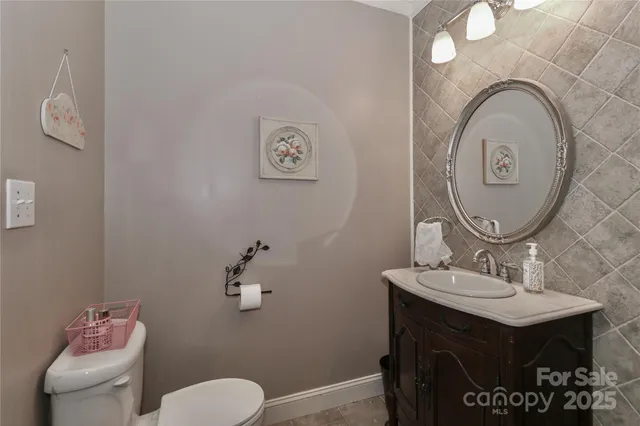 a bathroom with a toilet a sink and mirror