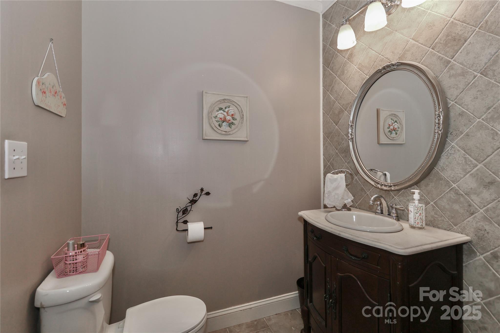 625 St Andrews Road Statesville, NC 28625 - Photo 22 of 48 a bathroom with a toilet a sink and mirror