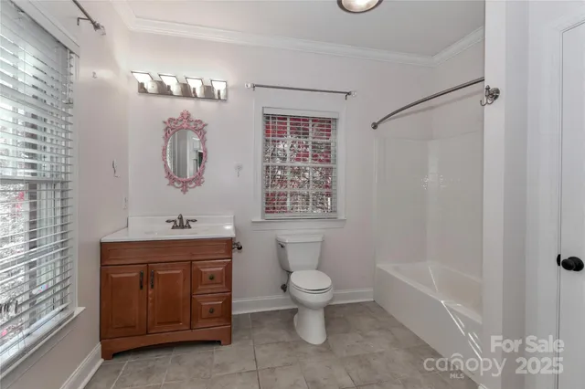 a bathroom with a toilet sink and shower