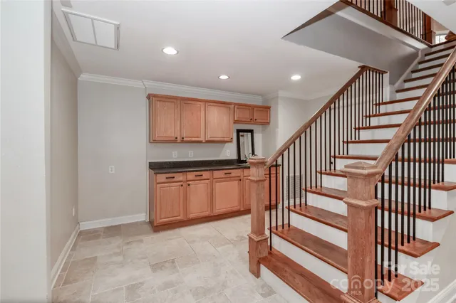 a room with pool table and windows