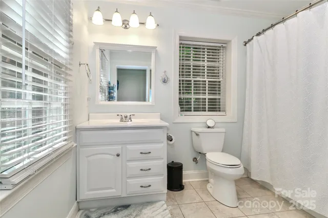 a bedroom with a bed gym equipment and a window