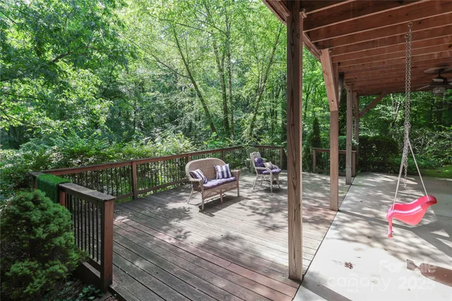 a view of a patio with table and chairs and wooden fence