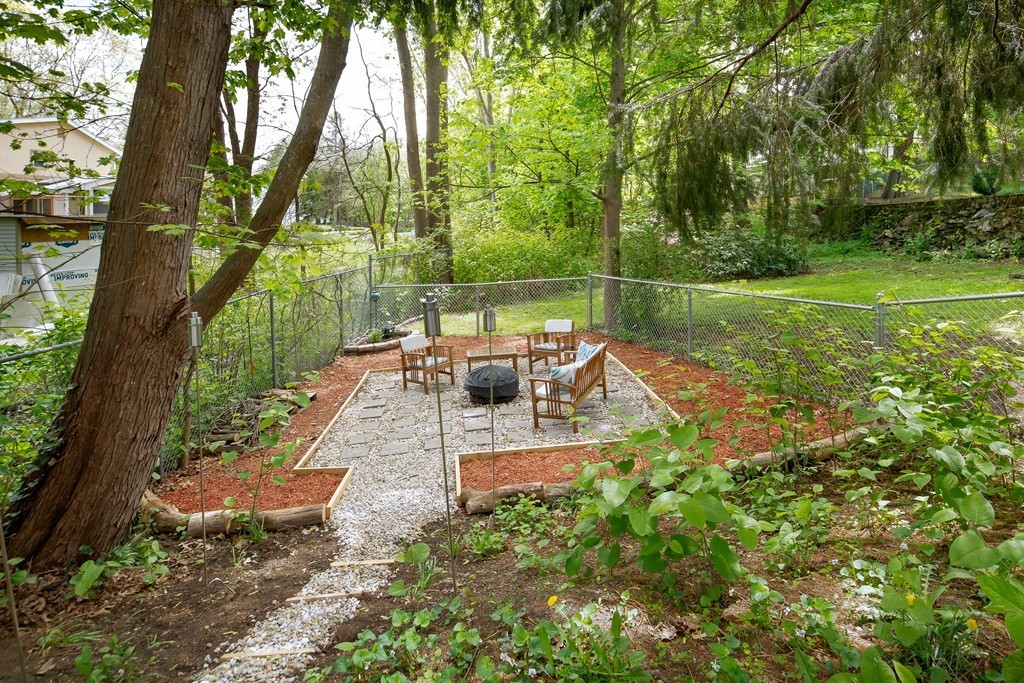 79 Colonial Drive Dedham, MA 02026 - Photo 11 of 12 a view of a chair and tables in the garden