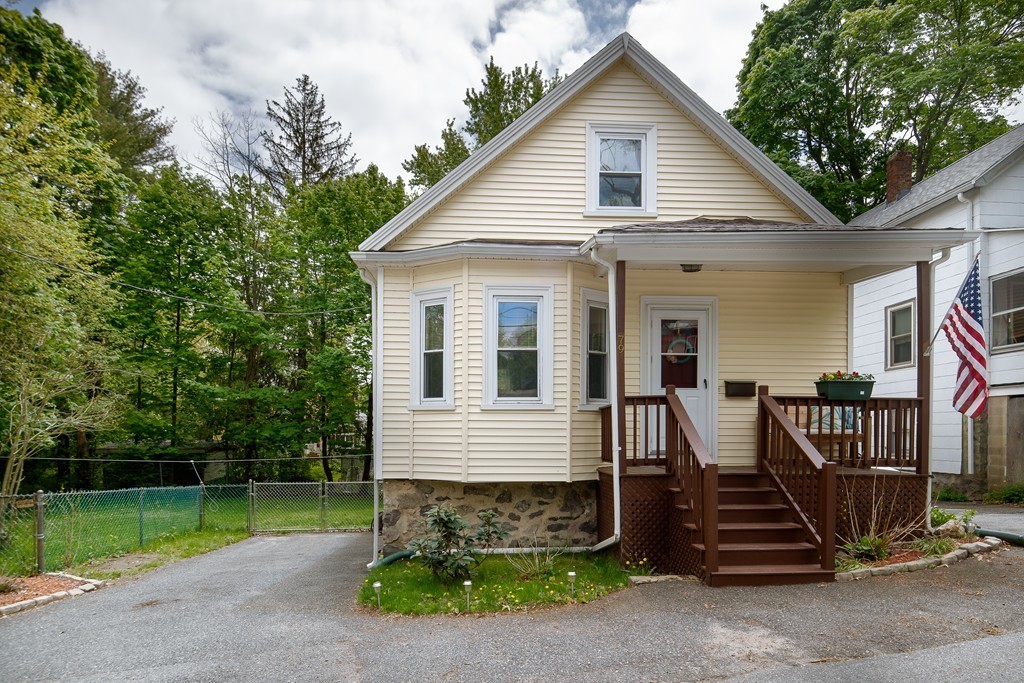 79 Colonial Drive Dedham, MA 02026 - Photo 9 of 12 a front view of a house with garden