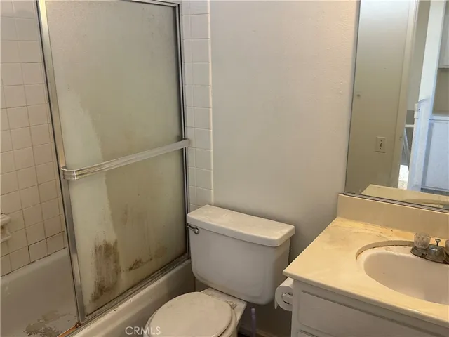 a white toilet sitting next to a bathroom sink