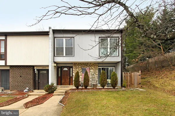a front view of a house with a yard garage and outdoor seating