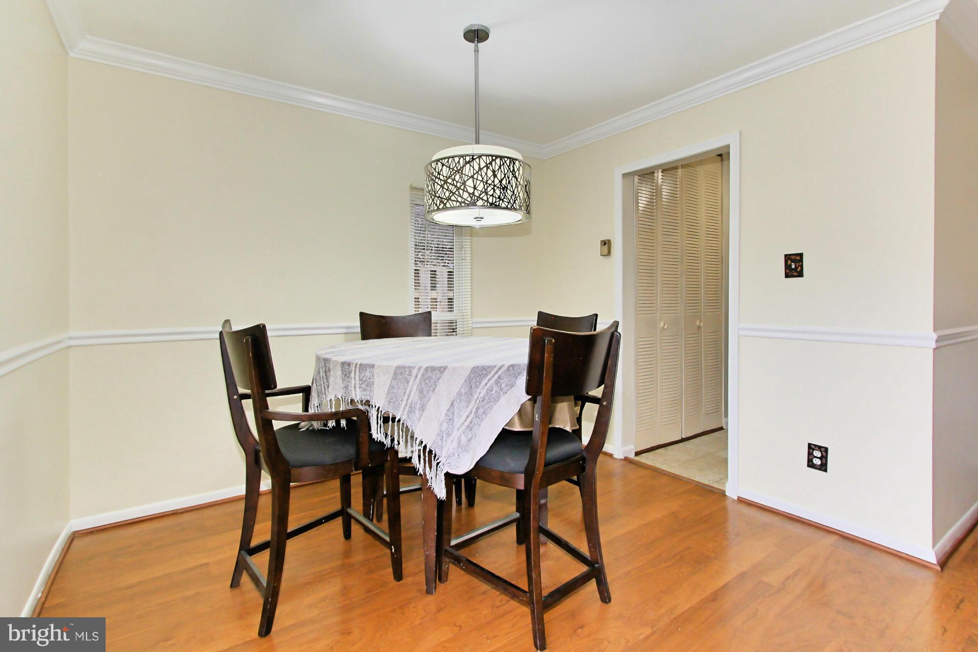 6340 Rockshire Street Alexandria, VA 22315 - Photo 12 of 30 a view of a dining room with furniture and wooden floor