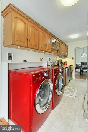 a kitchen with kitchen island granite countertop a sink a counter space and cabinets
