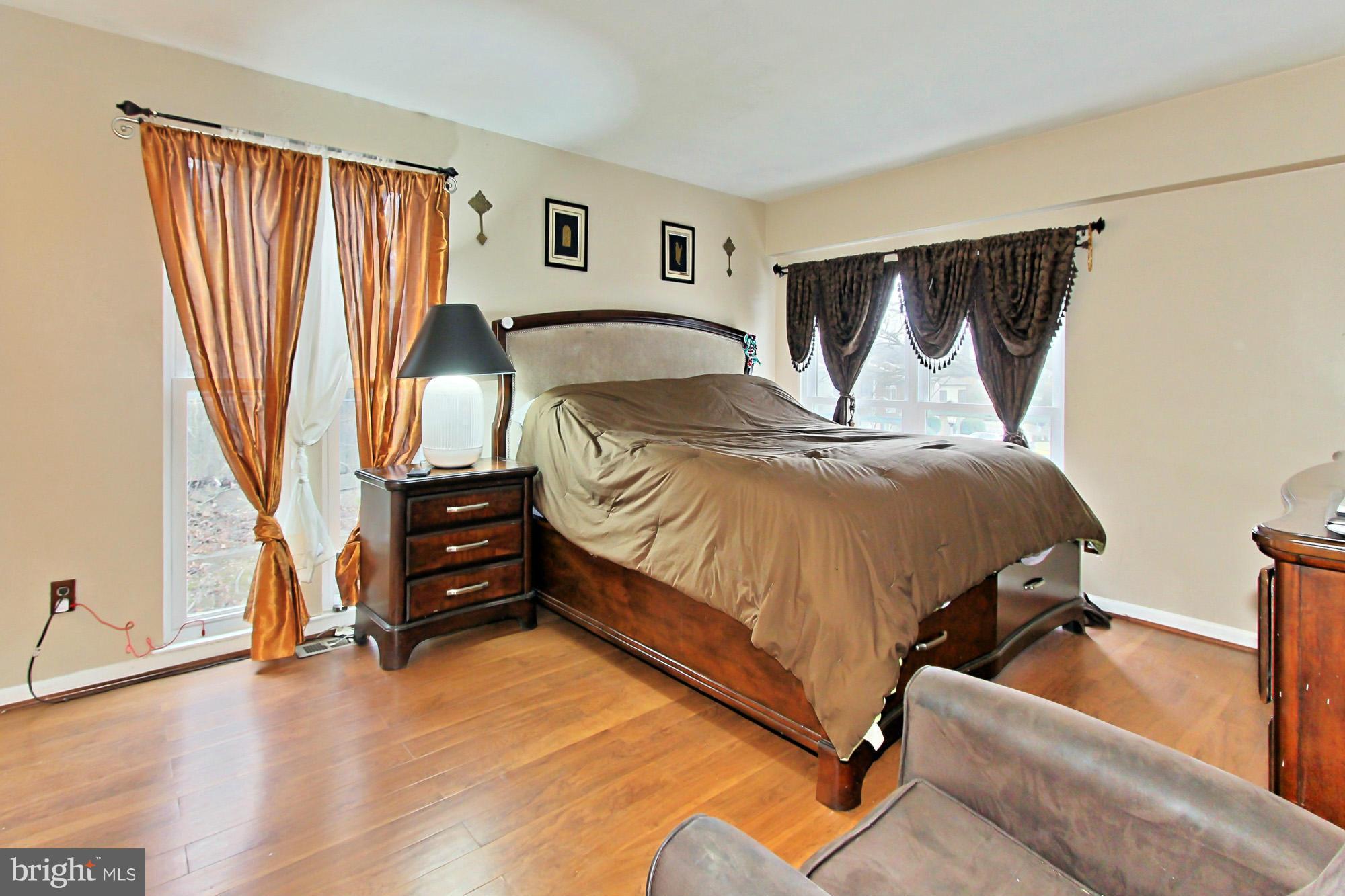 6340 Rockshire Street Alexandria, VA 22315 - Photo 20 of 30 a bedroom with a bed and wooden floor