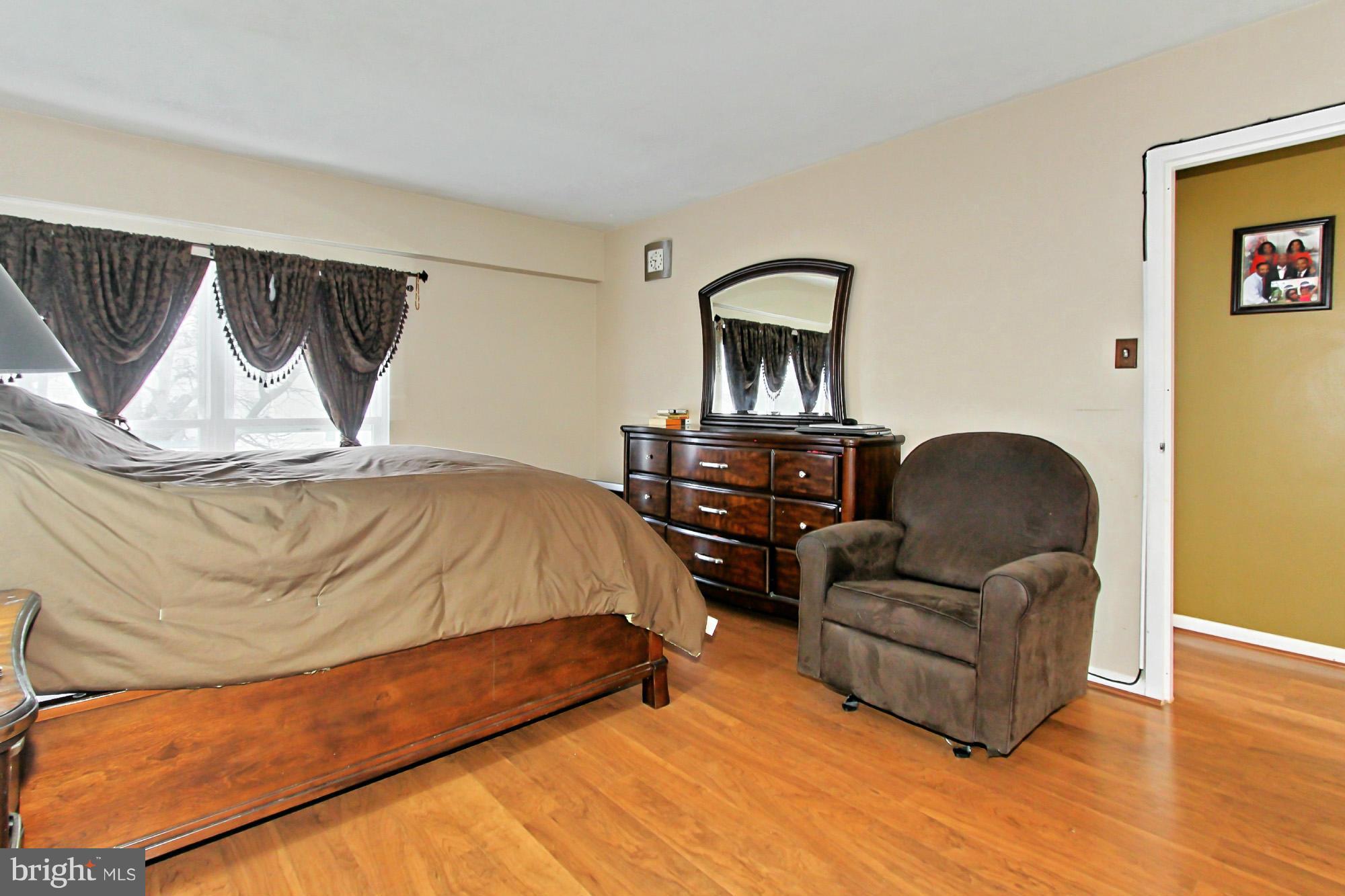 6340 Rockshire Street Alexandria, VA 22315 - Photo 21 of 30 a bedroom with a bed and wooden floor