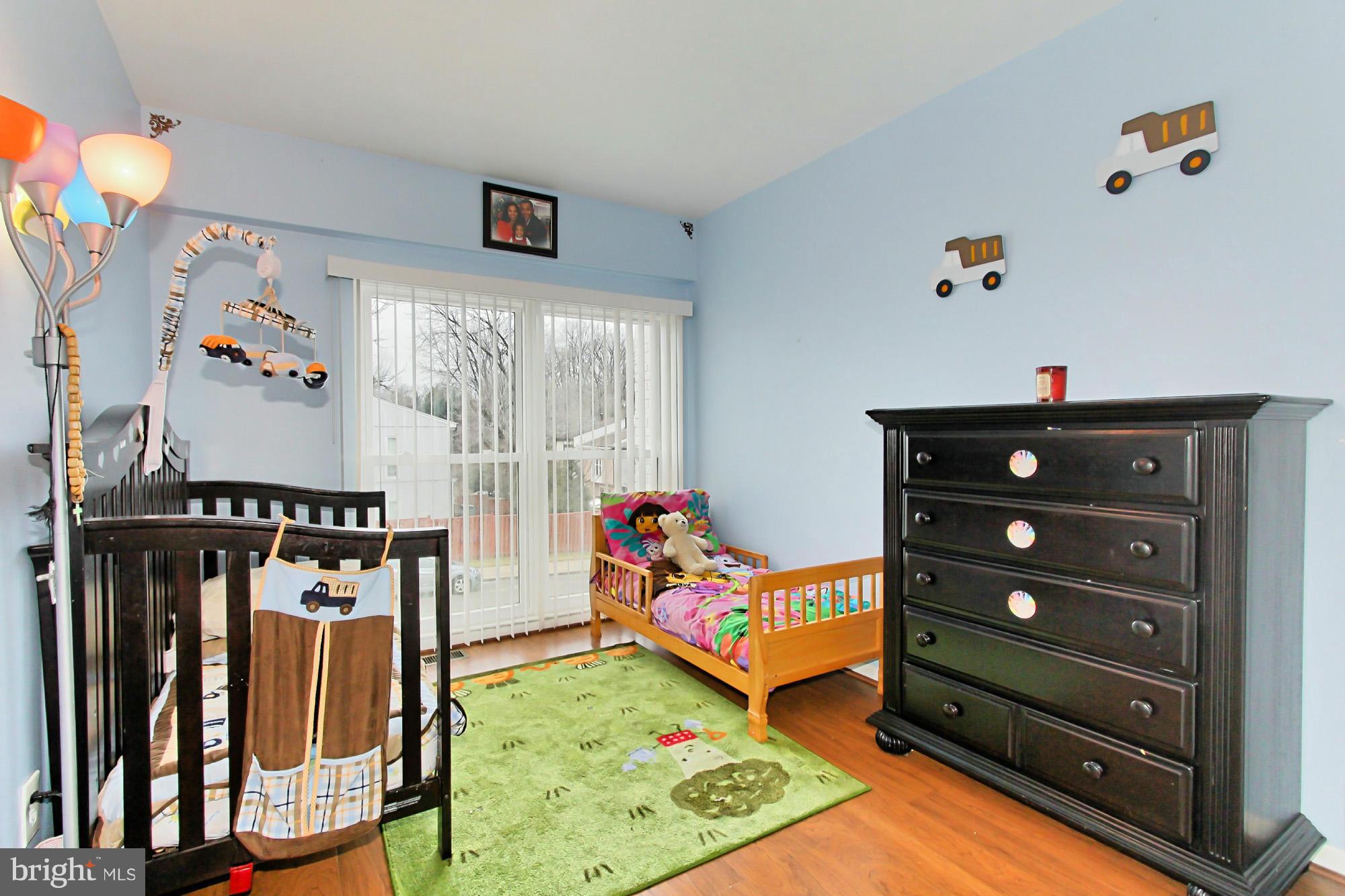 6340 Rockshire Street Alexandria, VA 22315 - Photo 25 of 30 a living room with lots of furniture and baby bed