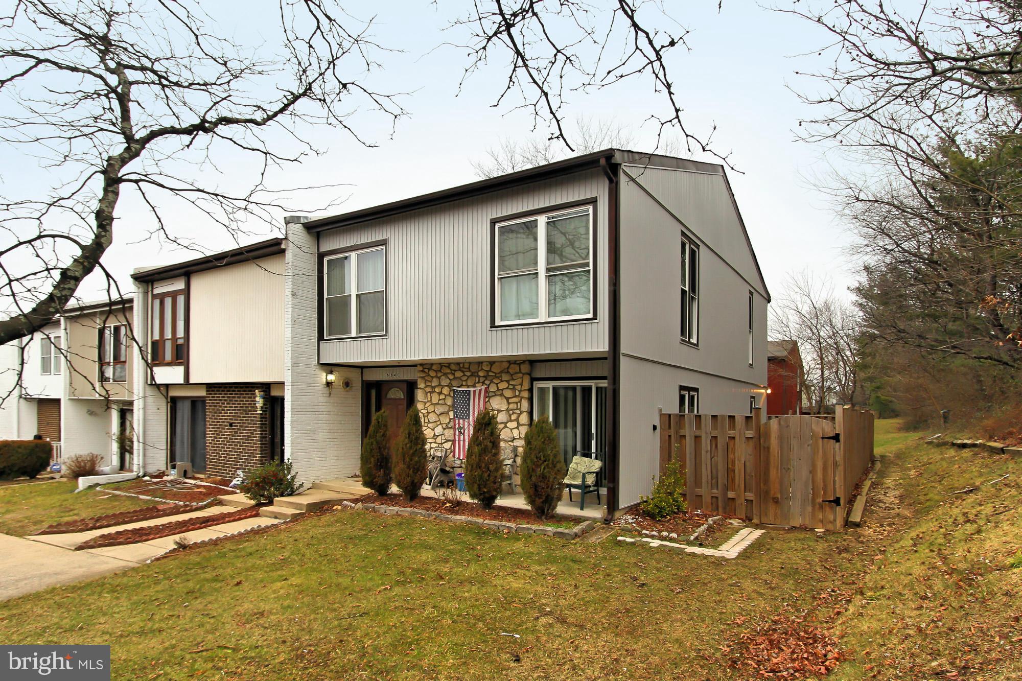 6340 Rockshire Street Alexandria, VA 22315 - Photo 3 of 30 a front view of a house with basket ball court and a yard