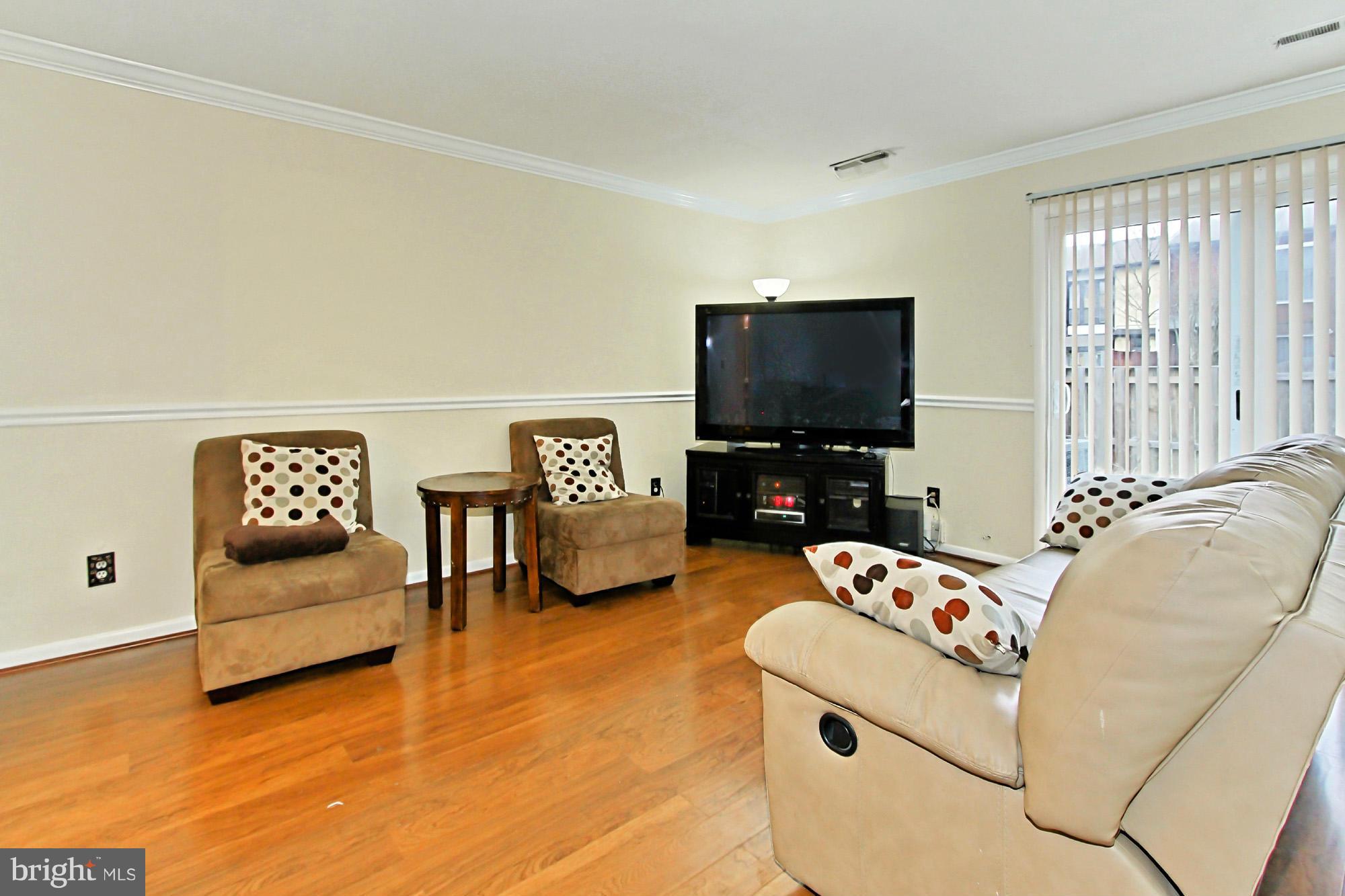 6340 Rockshire Street Alexandria, VA 22315 - Photo 9 of 30 a living room with furniture and a flat screen tv