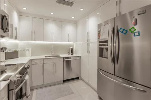 a kitchen with a sink stainless steel appliances and cabinets