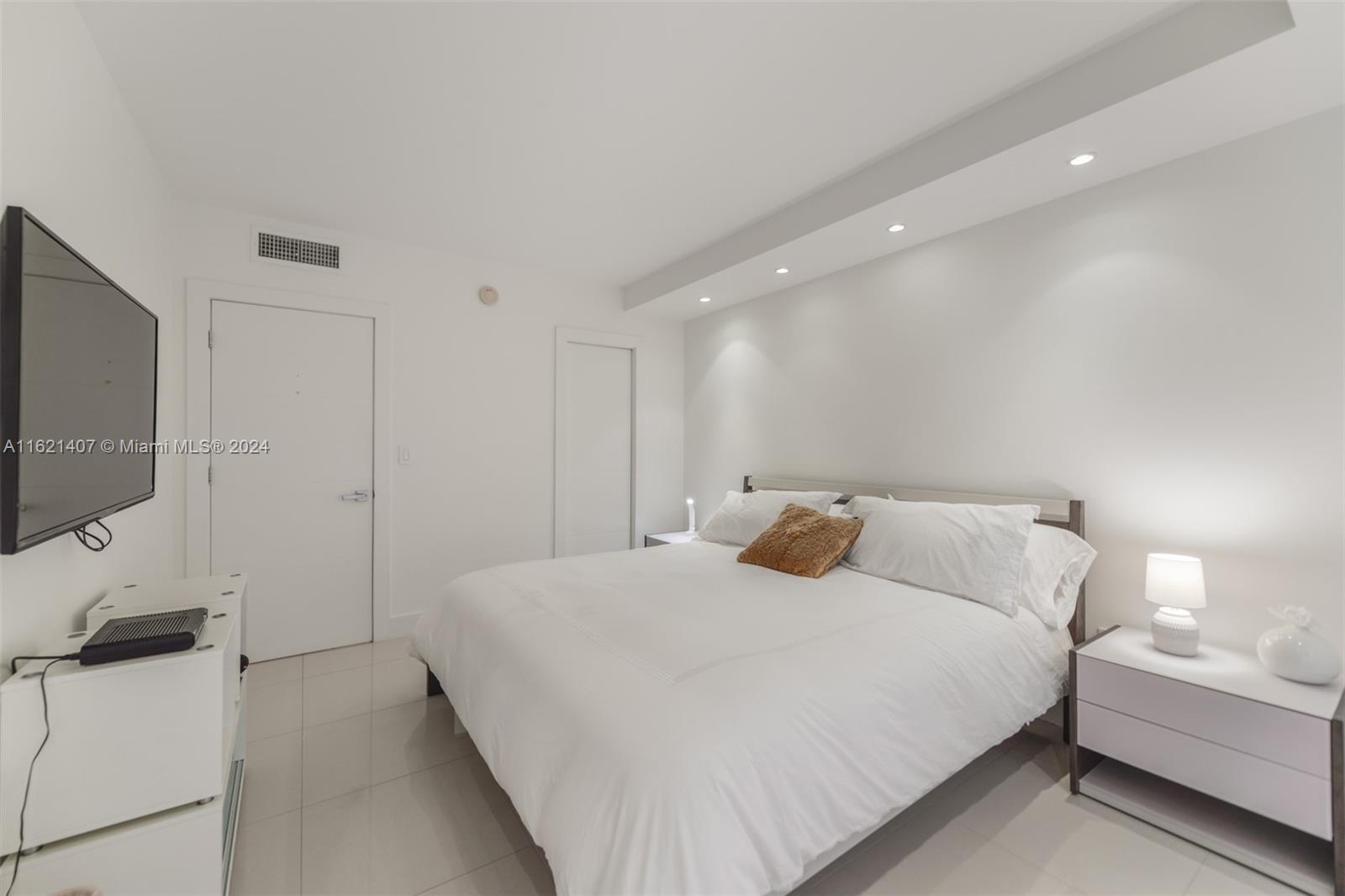 1950 South Ocean Drive, Unit 19G Hallandale Beach, FL 33009 - Photo 19 of 33 a bedroom with a bed and a flat screen tv