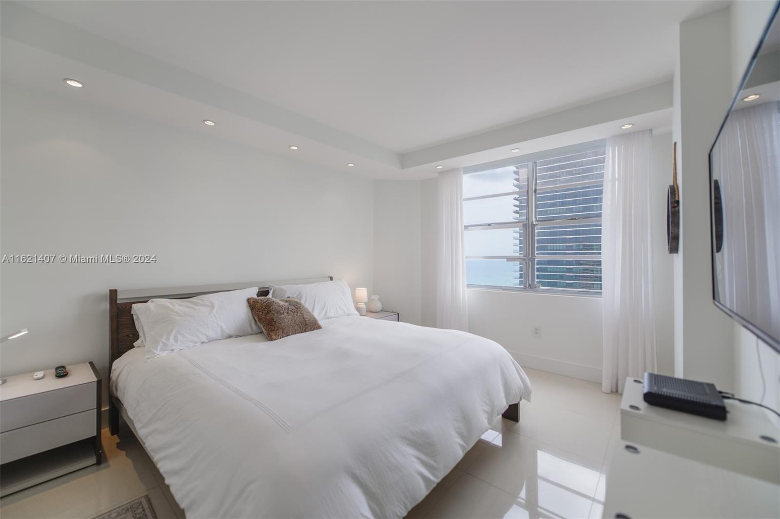 1950 South Ocean Drive, Unit 19G Hallandale Beach, FL 33009 - Photo 20 of 33 a bedroom with a bed and a large window