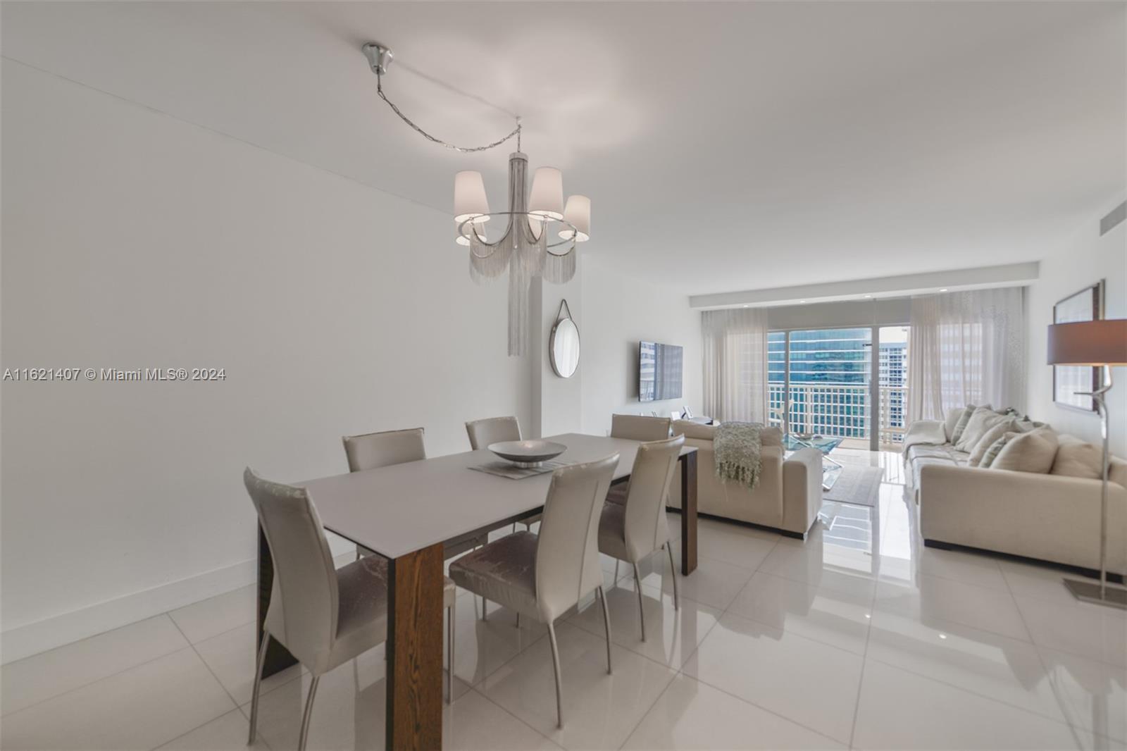 1950 South Ocean Drive, Unit 19G Hallandale Beach, FL 33009 - Photo 2 of 33 a view of a dining room with furniture a livingroom and chandelier