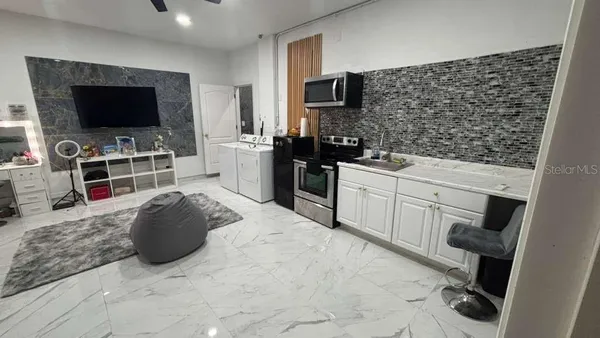 a kitchen with stainless steel appliances a stove a sink and a microwave